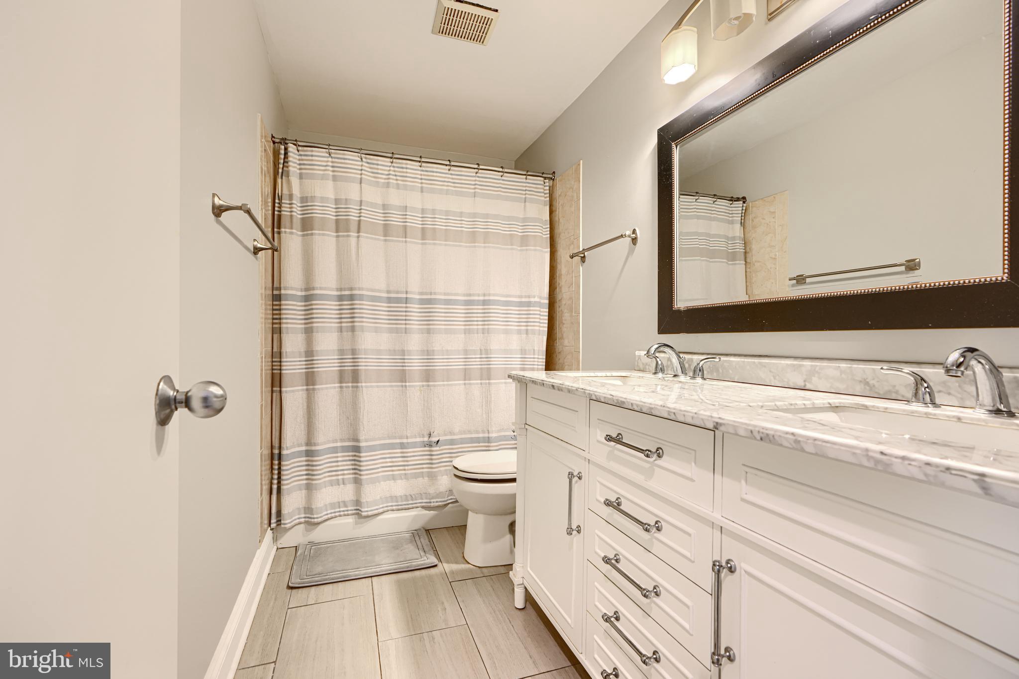 123 West Barre Street, Unit 103 Baltimore, MD 21201 - Photo 20 of 26 a bathroom with a sink a toilet and shower
