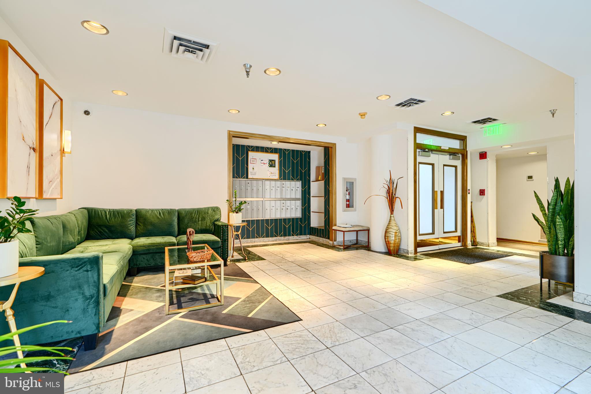 123 West Barre Street, Unit 103 Baltimore, MD 21201 - Photo 23 of 26 a living room with furniture a dining table and a potted plant