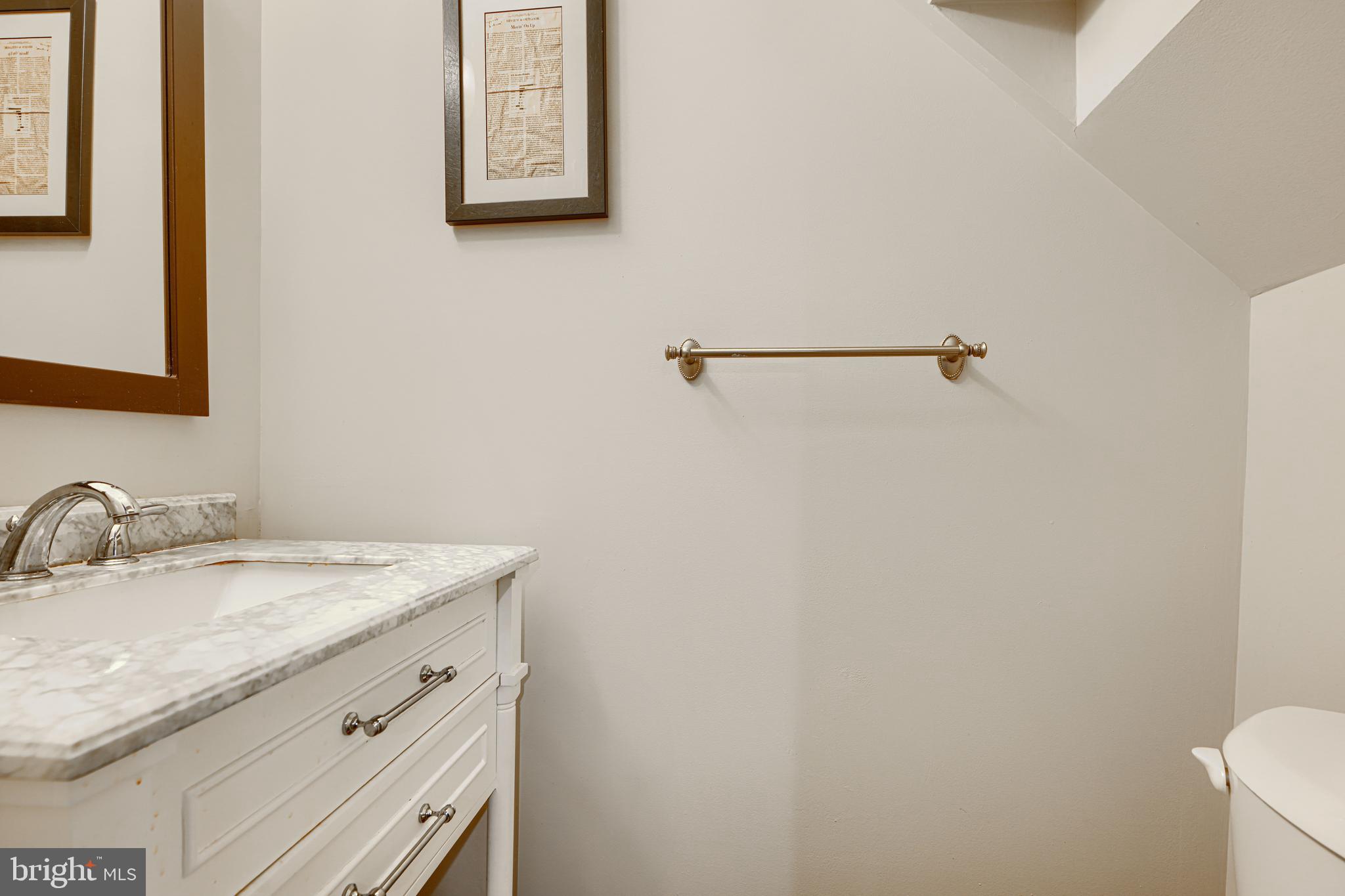 123 West Barre Street, Unit 103 Baltimore, MD 21201 - Photo 6 of 26 a bathroom with a granite countertop sink and a mirror