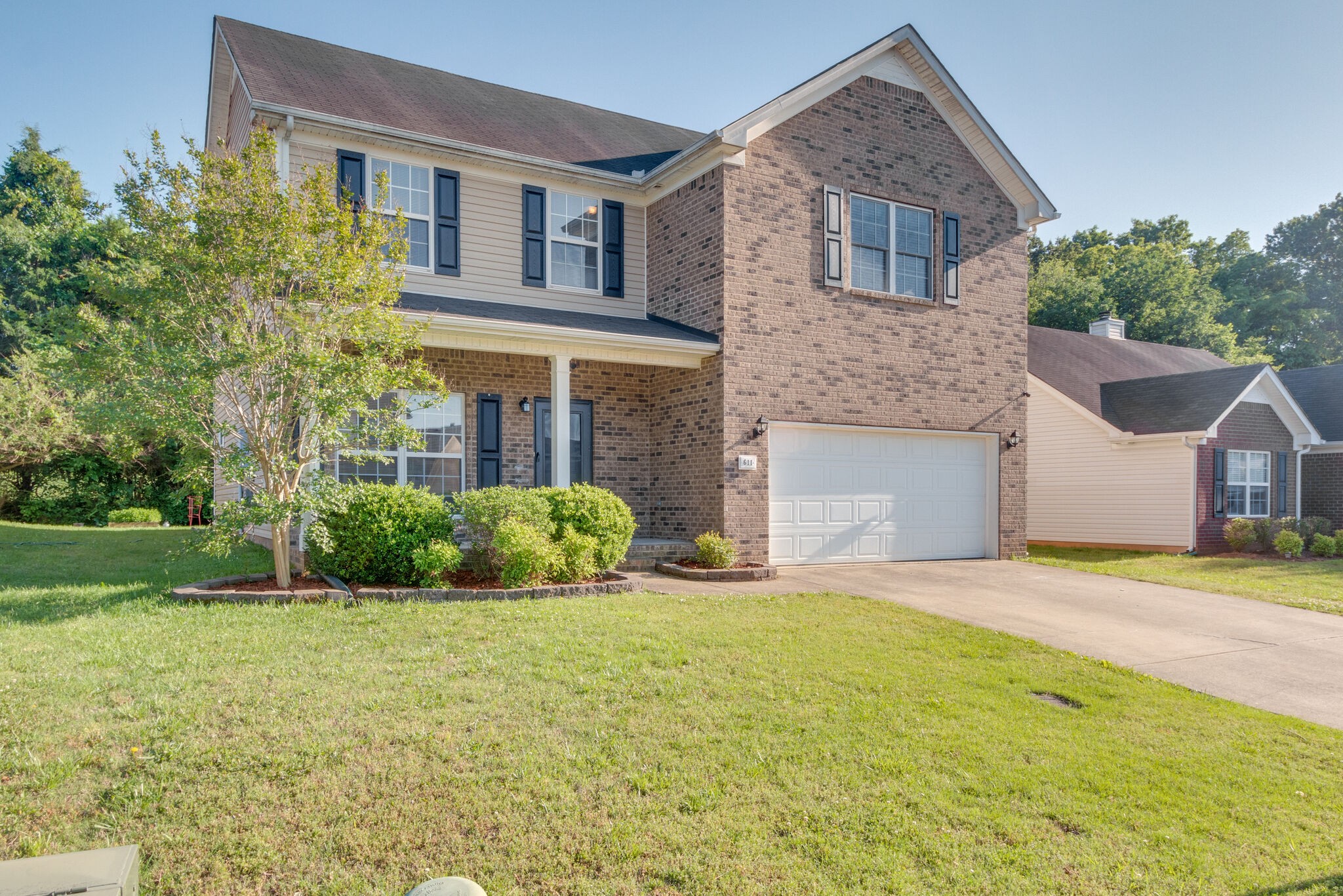 611 Buck Cherry Way Murfreesboro, TN 37128 - Photo 1 of 36 a front view of a house with a yard and garage