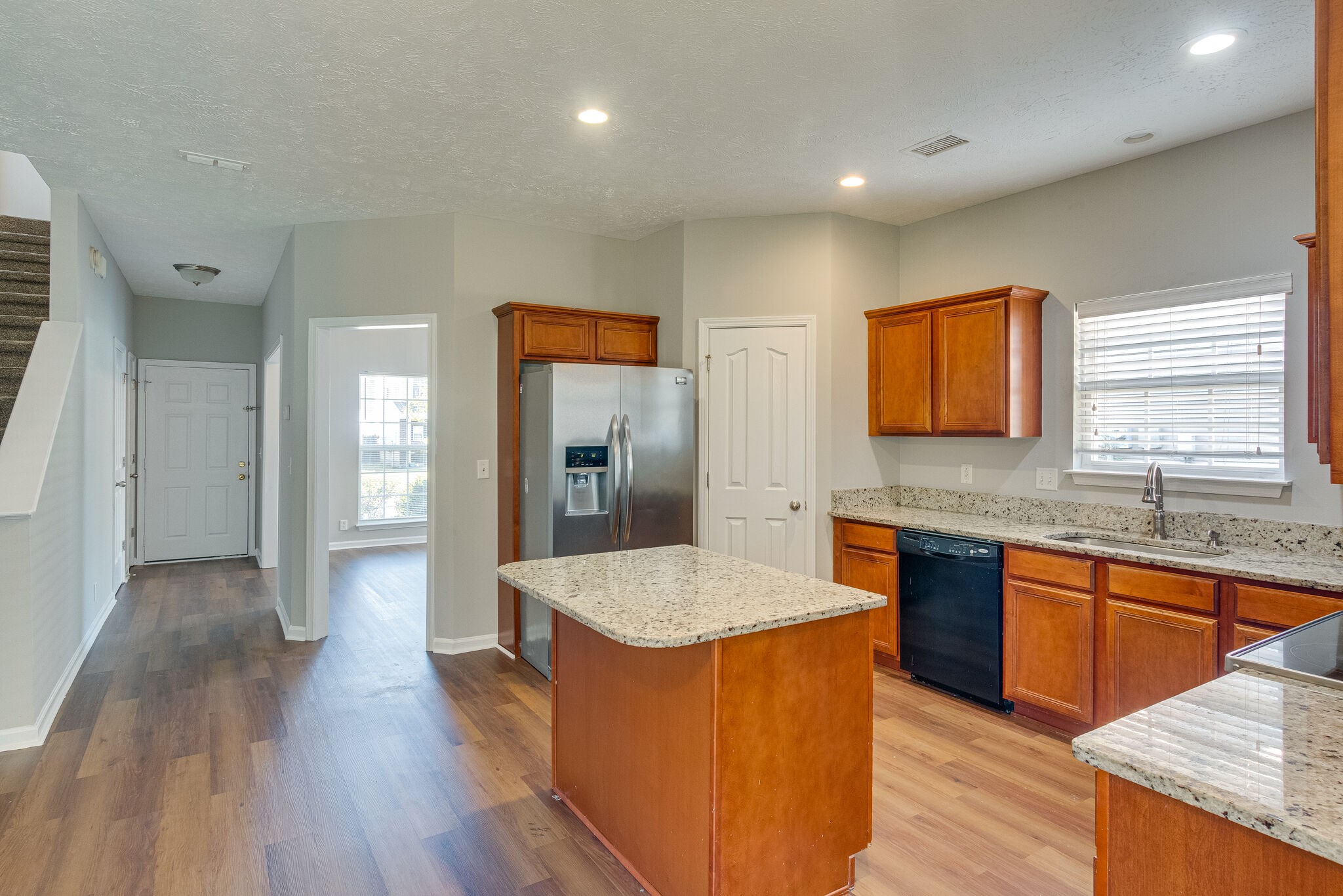 611 Buck Cherry Way Murfreesboro, TN 37128 - Photo 15 of 36 a large kitchen with stainless steel appliances granite countertop a lot of counter space and wooden floor