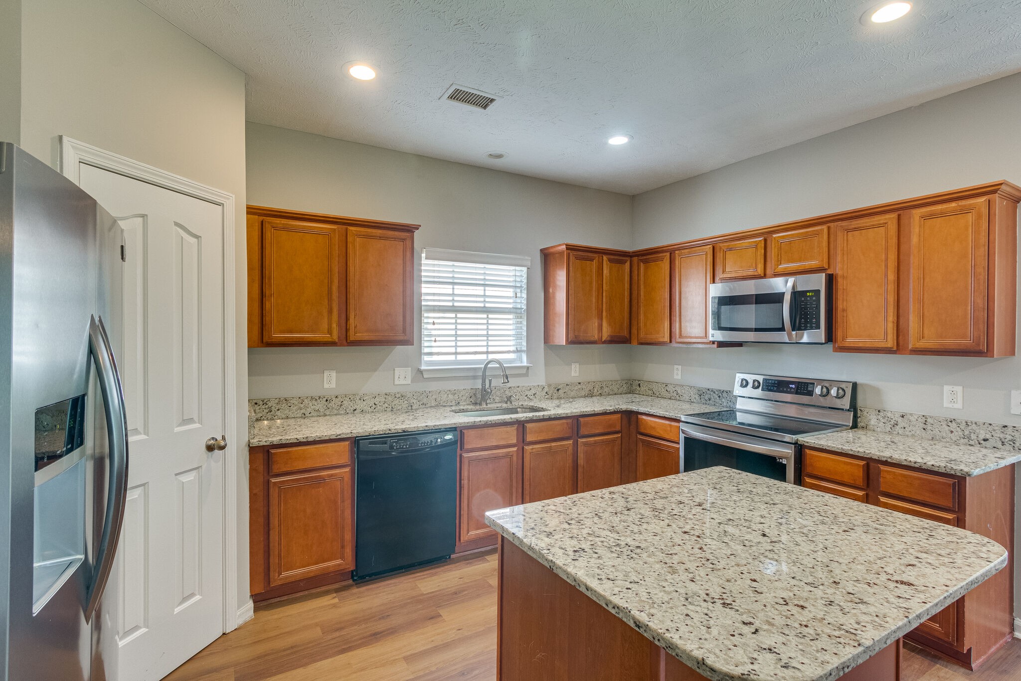 611 Buck Cherry Way Murfreesboro, TN 37128 - Photo 16 of 36 a kitchen with stainless steel appliances granite countertop a sink stove refrigerator and wooden cabinets