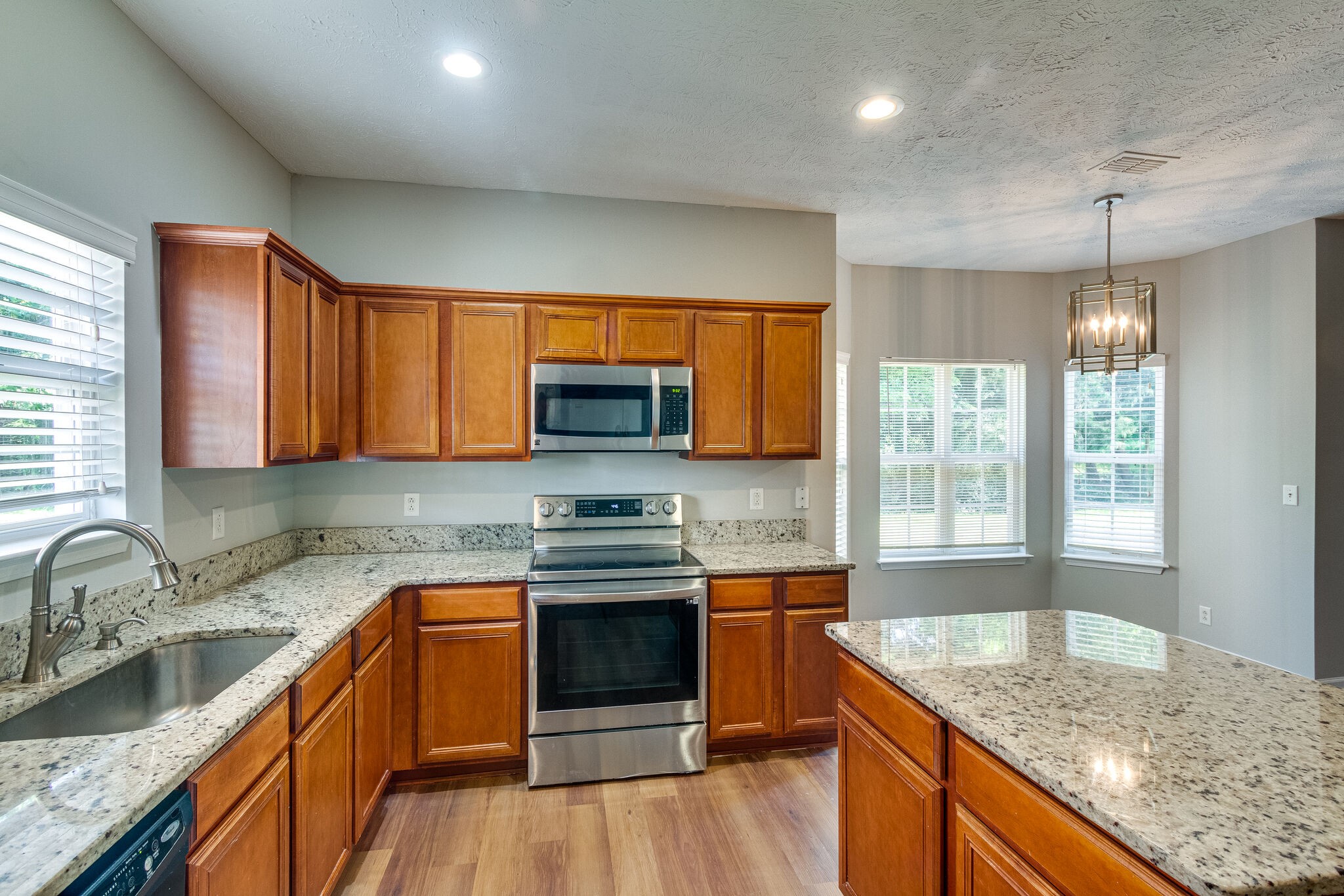 611 Buck Cherry Way Murfreesboro, TN 37128 - Photo 17 of 36 a kitchen with stainless steel appliances granite countertop wooden cabinets a sink and a stove