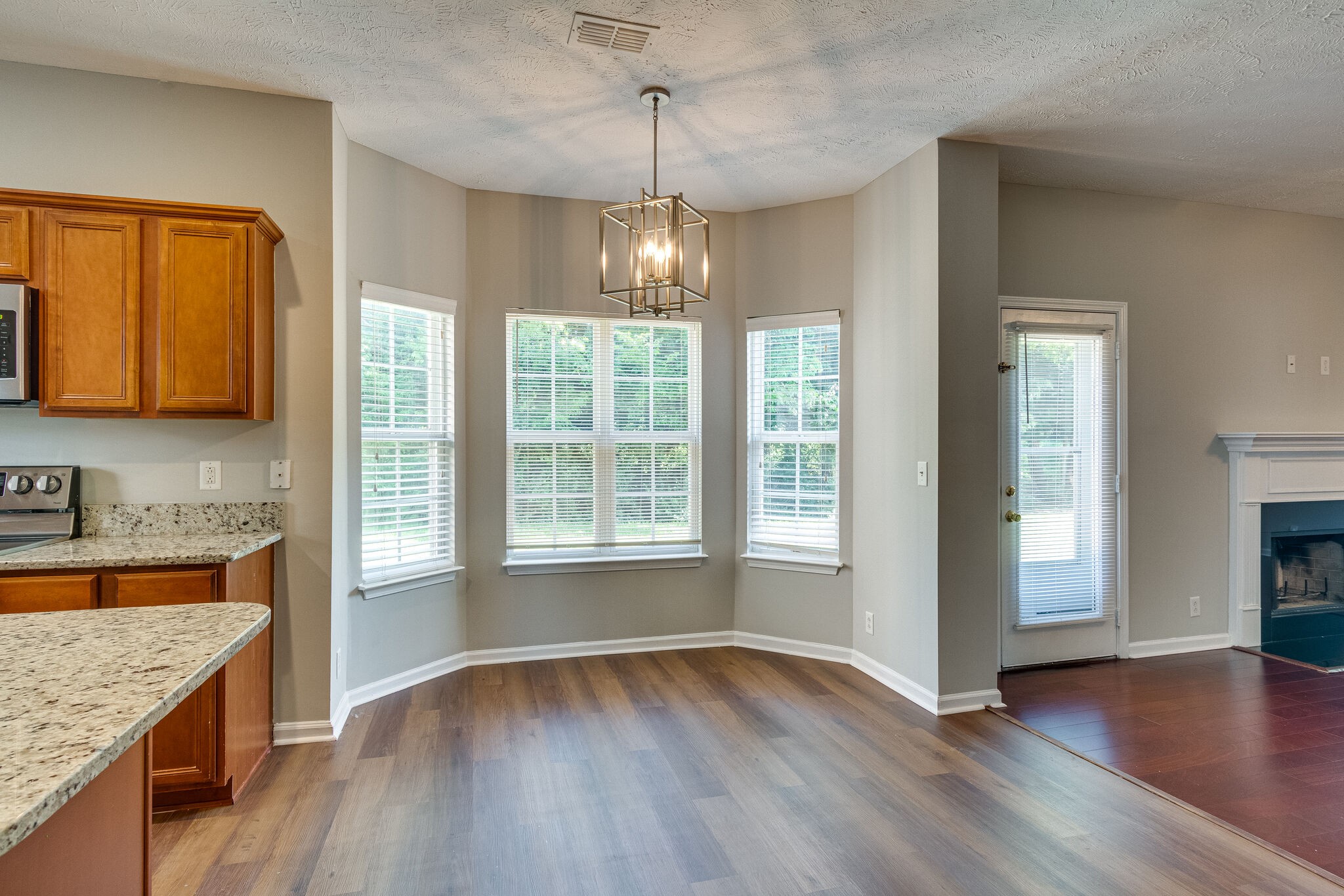 611 Buck Cherry Way Murfreesboro, TN 37128 - Photo 18 of 36 a view of an empty room with window and wooden floor