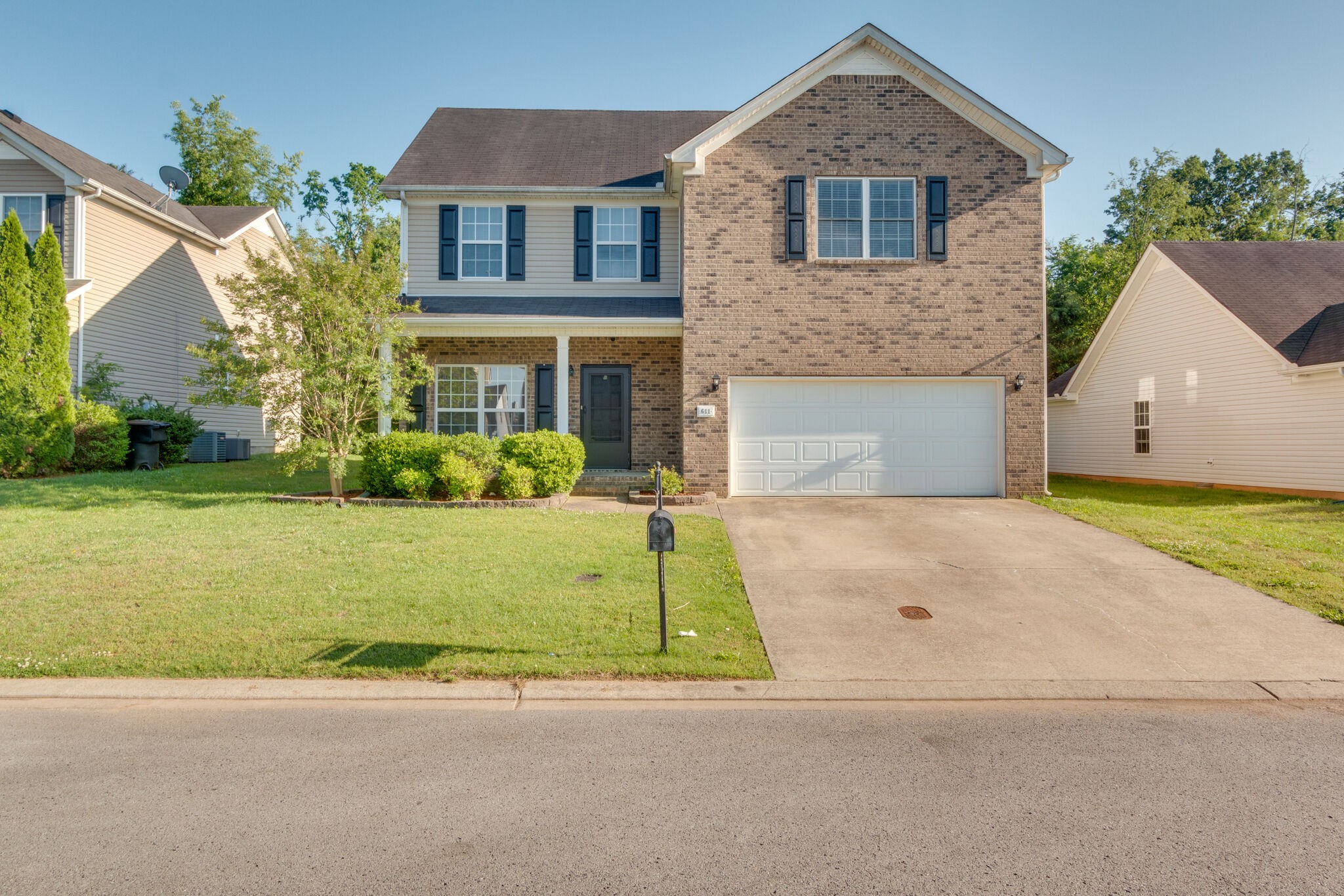 611 Buck Cherry Way Murfreesboro, TN 37128 - Photo 2 of 36 a front view of a house with garden