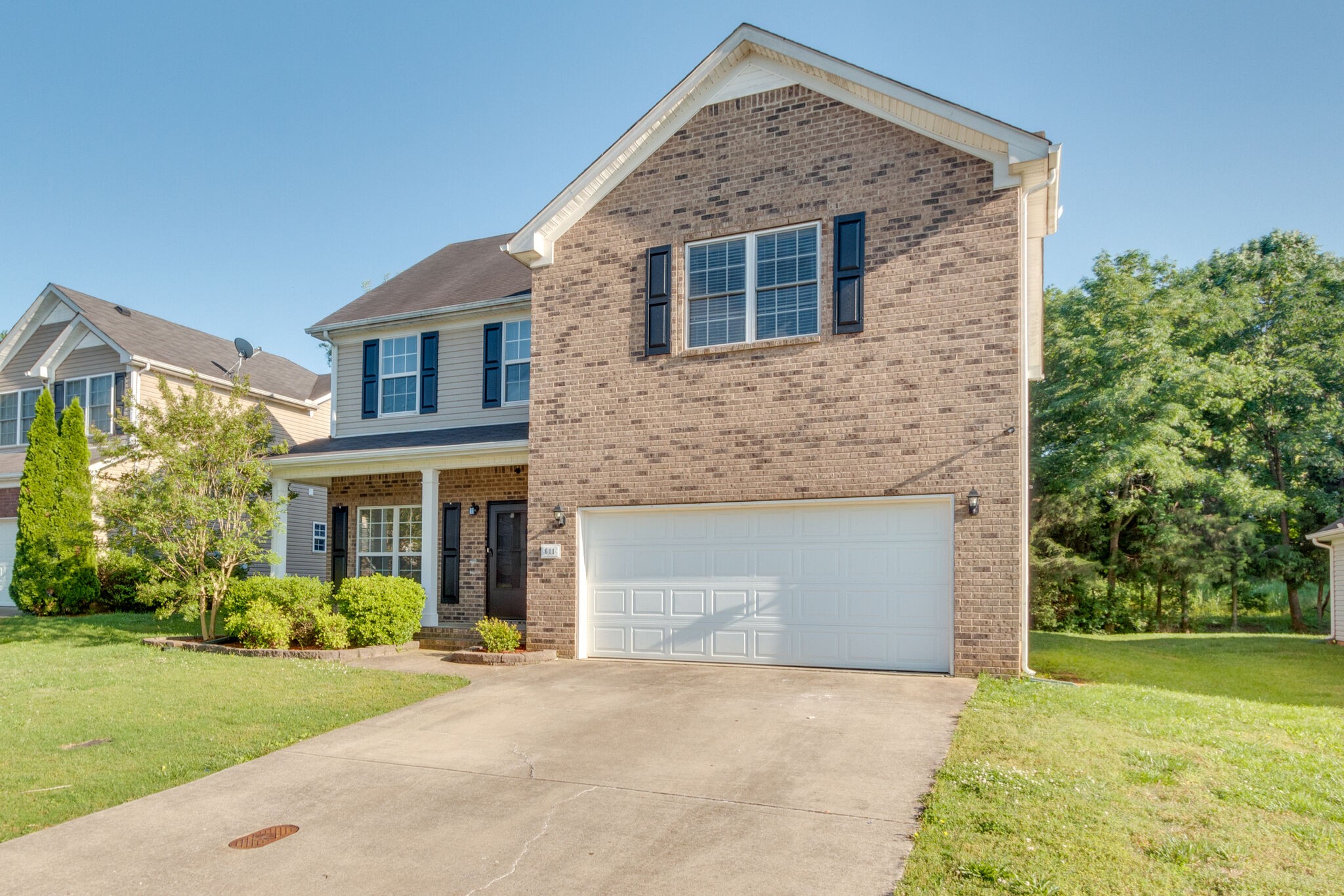 611 Buck Cherry Way Murfreesboro, TN 37128 - Photo 3 of 36 a front view of a house with garden