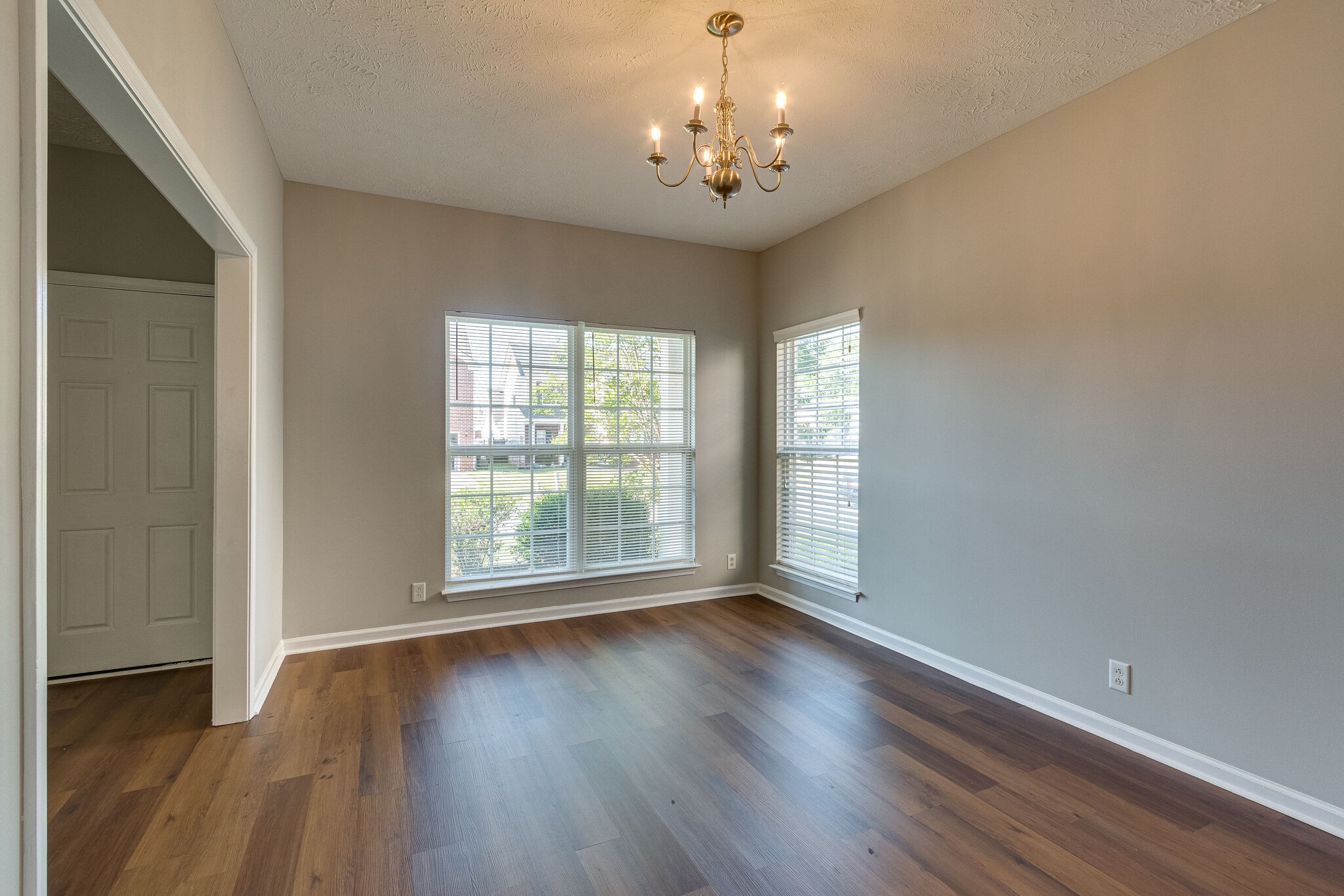 611 Buck Cherry Way Murfreesboro, TN 37128 - Photo 9 of 36 a view of an empty room with wooden floor and a window