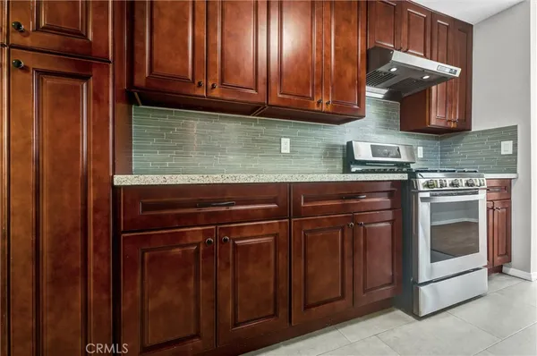 a kitchen with stainless steel appliances granite countertop wooden cabinets a sink and dishwasher