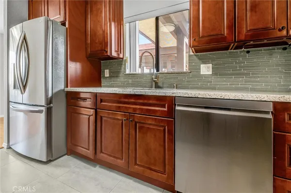 a kitchen with stainless steel appliances granite countertop a refrigerator sink and cabinets