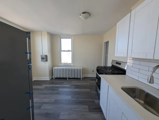 a kitchen with a sink a stove and cabinets