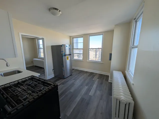 a living room with hard wood floors and a fireplace