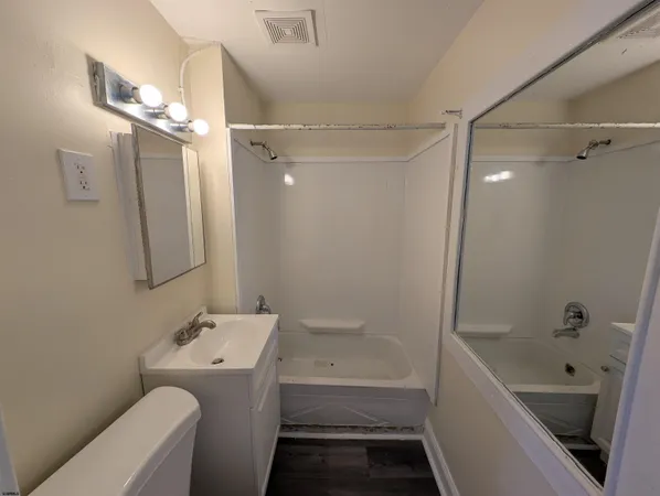 a kitchen with a sink a stove and cabinets
