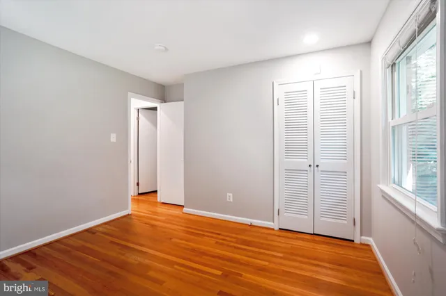 a view of an empty room with a fireplace and a window