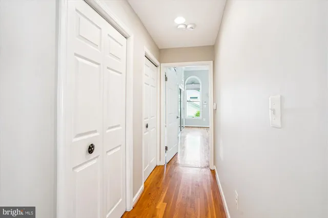 a view of a hallway with wooden floor