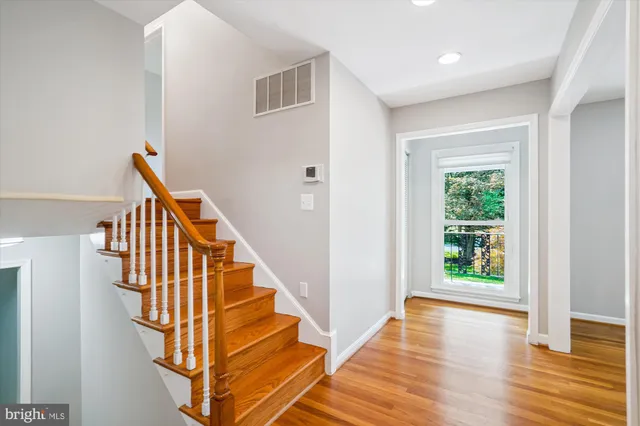a view of an empty room with a cabinet and a window