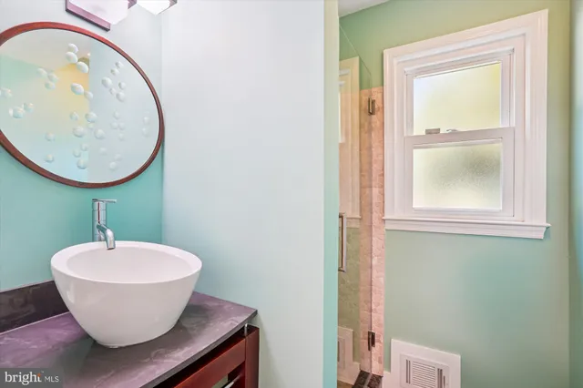a front view of a house with a garden and trees