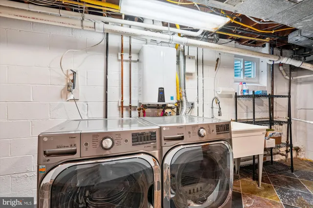 an aerial view of residential house with outdoor space and trees all around