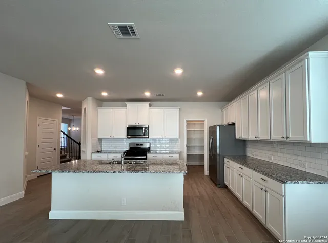 a large kitchen with stainless steel appliances