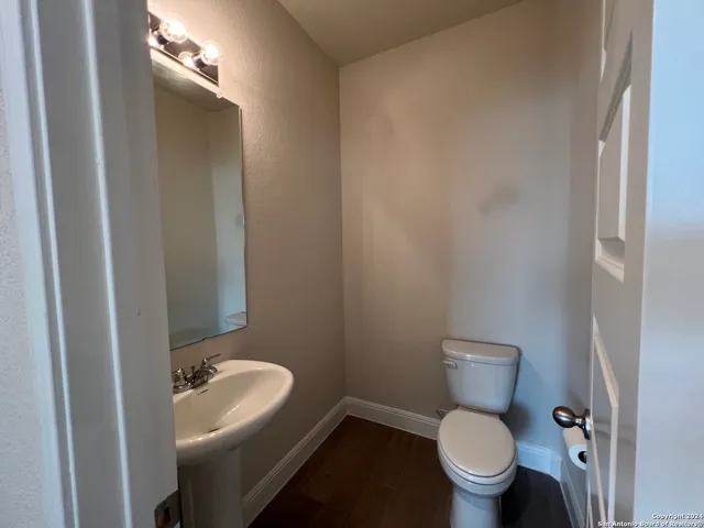 a white toilet sitting next to a bathroom sink