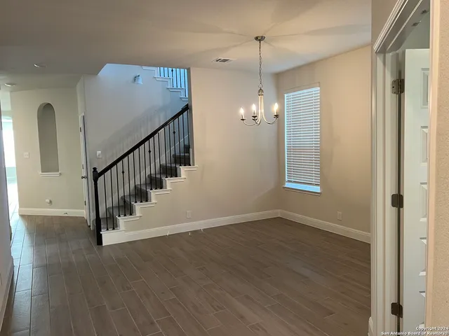 a view of an entryway with wooden floor