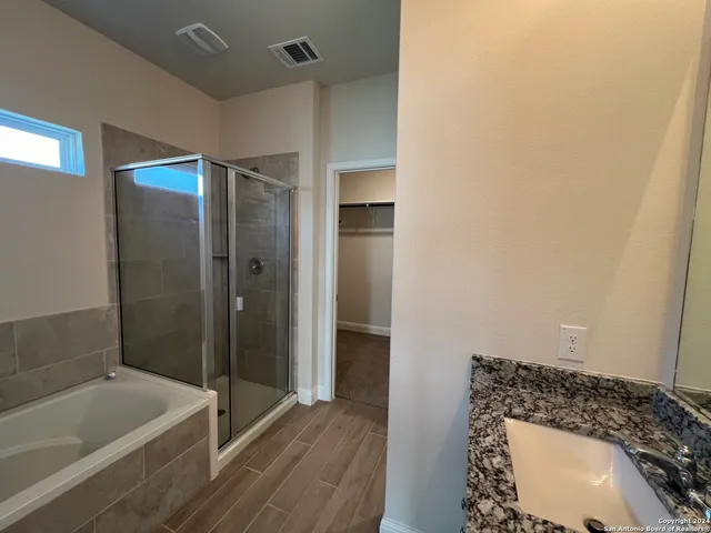 a bathroom with a bathtub and shower