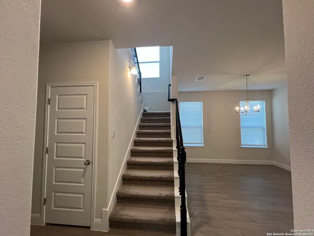 a view of an entryway with wooden floor