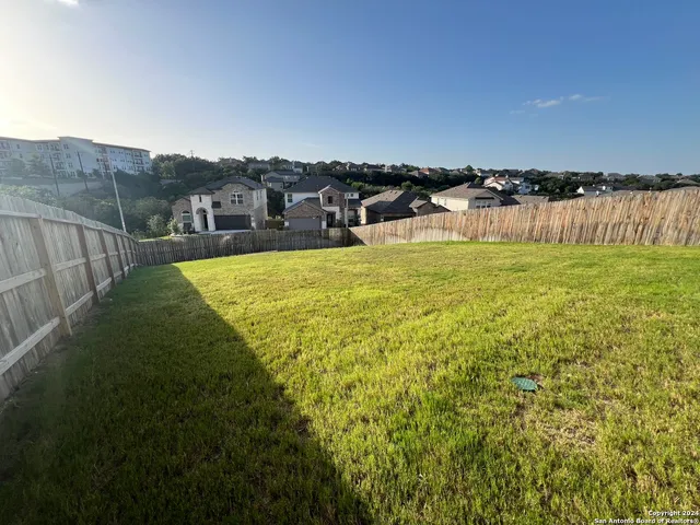 a view of a lake with houses in back
