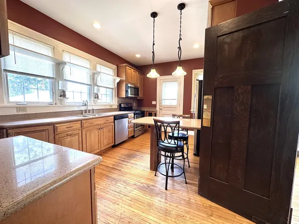 a open kitchen with sink and refrigerator