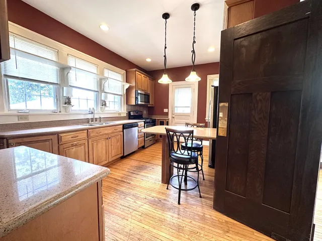 a open kitchen with sink and refrigerator