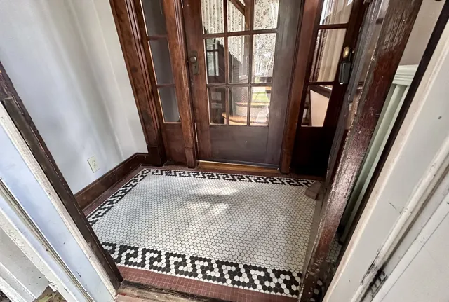 a view of entryway with wooden floor and stairs