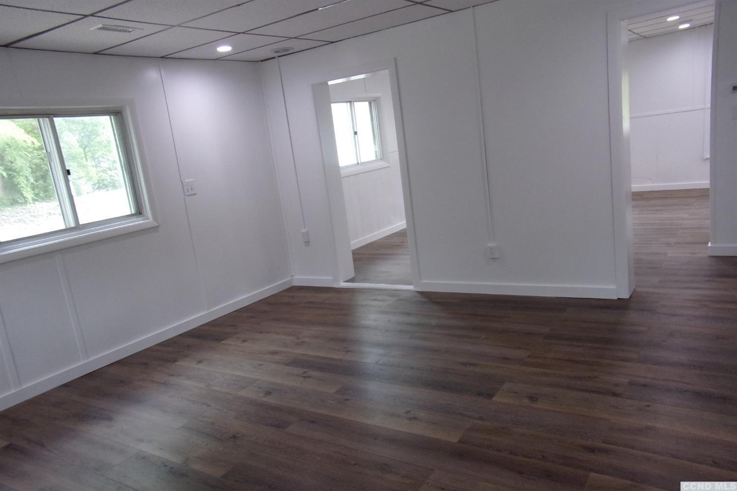 336 Main Street Cairo, NY 12413 - Photo 13 of 15 an empty room with wooden floor and windows