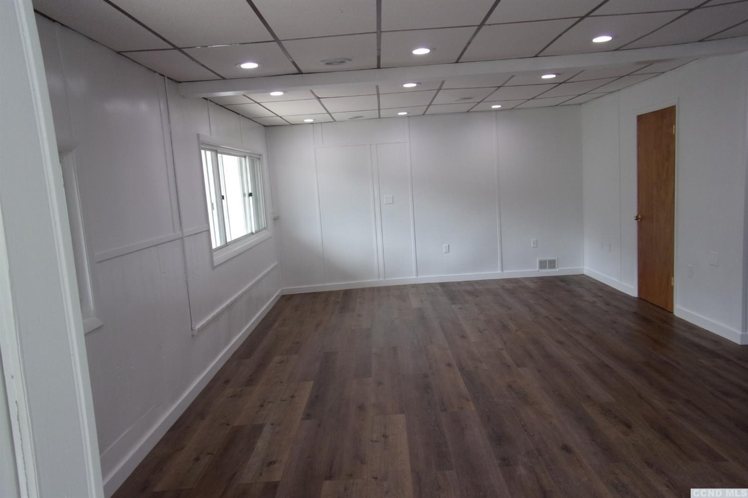 336 Main Street Cairo, NY 12413 - Photo 5 of 15 an empty room with wooden floor and windows