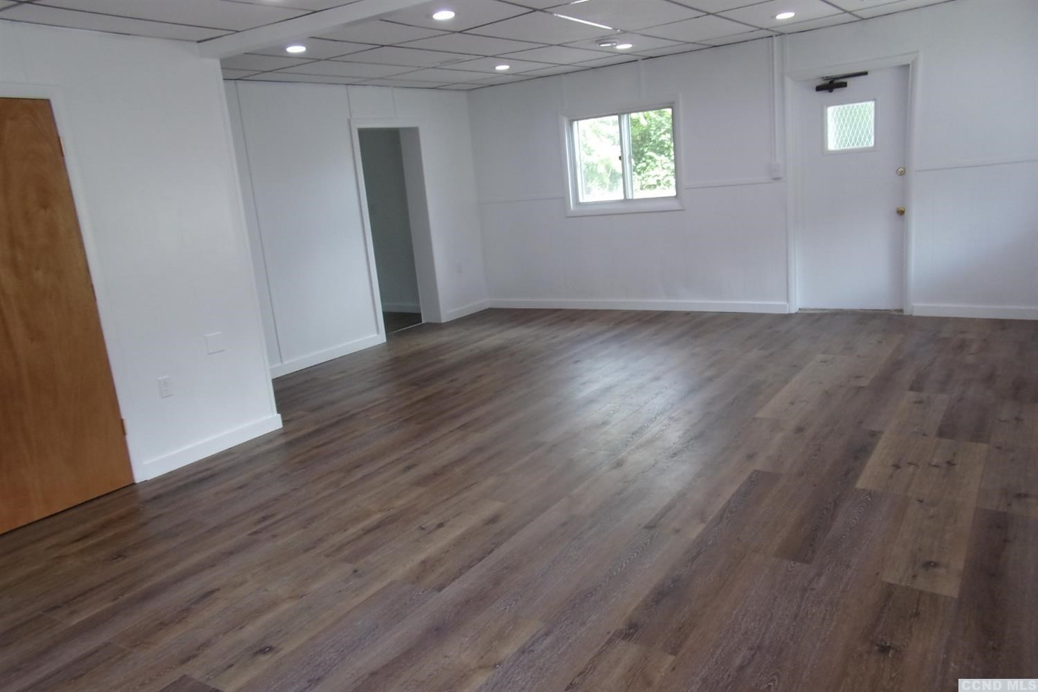 336 Main Street Cairo, NY 12413 - Photo 6 of 15 an empty room with wooden floor and windows