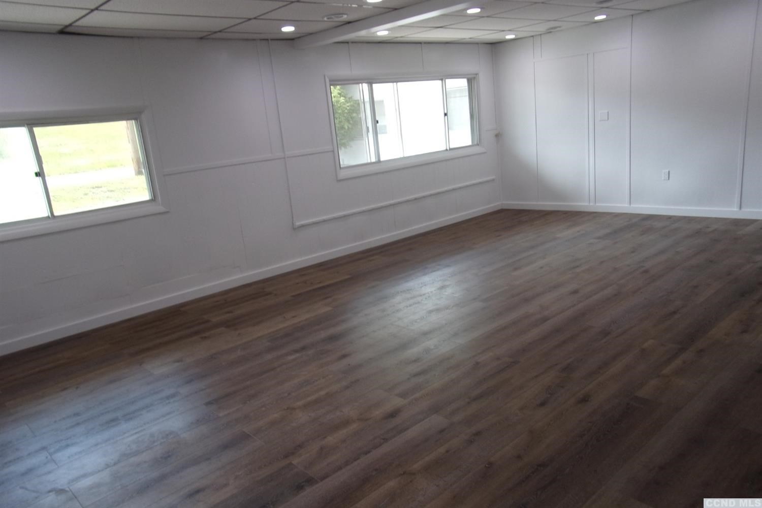 336 Main Street Cairo, NY 12413 - Photo 8 of 15 an empty room with wooden floor and windows