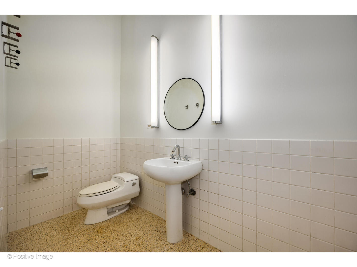 740 North Wells Street Chicago, IL 60654 - Photo 11 of 47 a bathroom with a sink toilet and a mirror