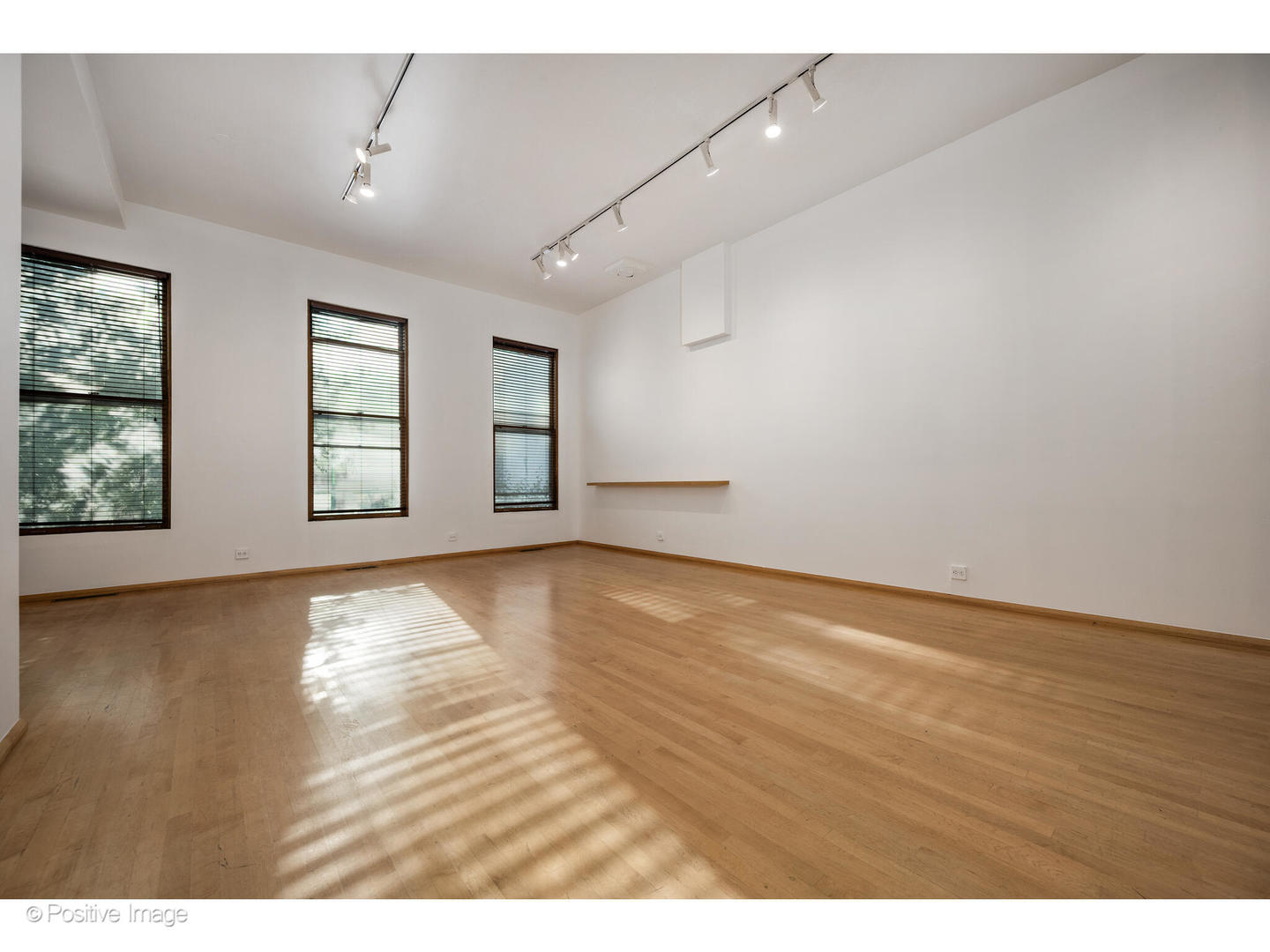 740 North Wells Street Chicago, IL 60654 - Photo 12 of 47 an empty room with wooden floor and windows