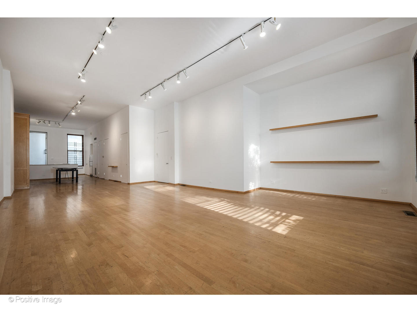 740 North Wells Street Chicago, IL 60654 - Photo 14 of 47 a view of empty room with wooden floor and kitchen view