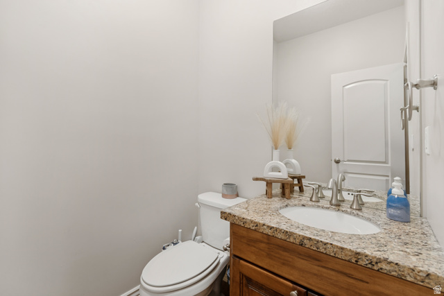7296 Ridge Road Lake Point, UT 84074 - Photo 30 of 54 Bathroom vanity featuring a granite countertop, undermount sink, and brushed nickel fixtures