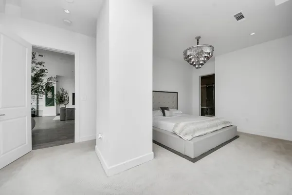 a spacious bedroom with a bed and a window