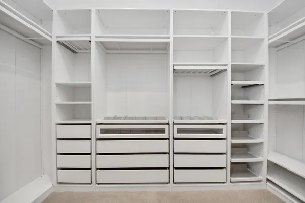 a view of walk in closet with empty racks