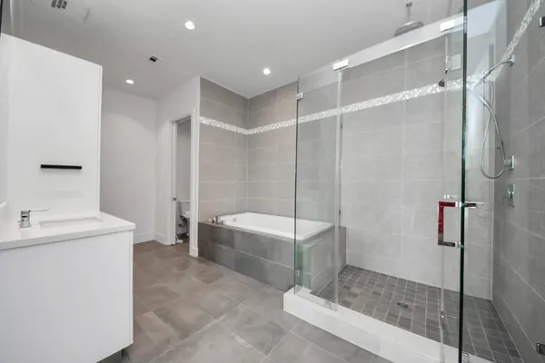 a bathroom with a tub and a sink