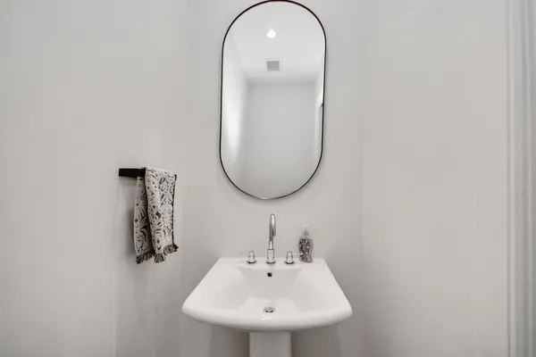 a view of a bathroom with a glass door shower and mirror
