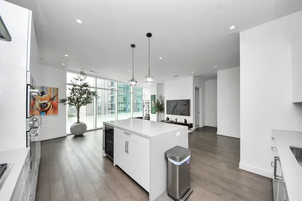 a kitchen with a sink and wooden floor