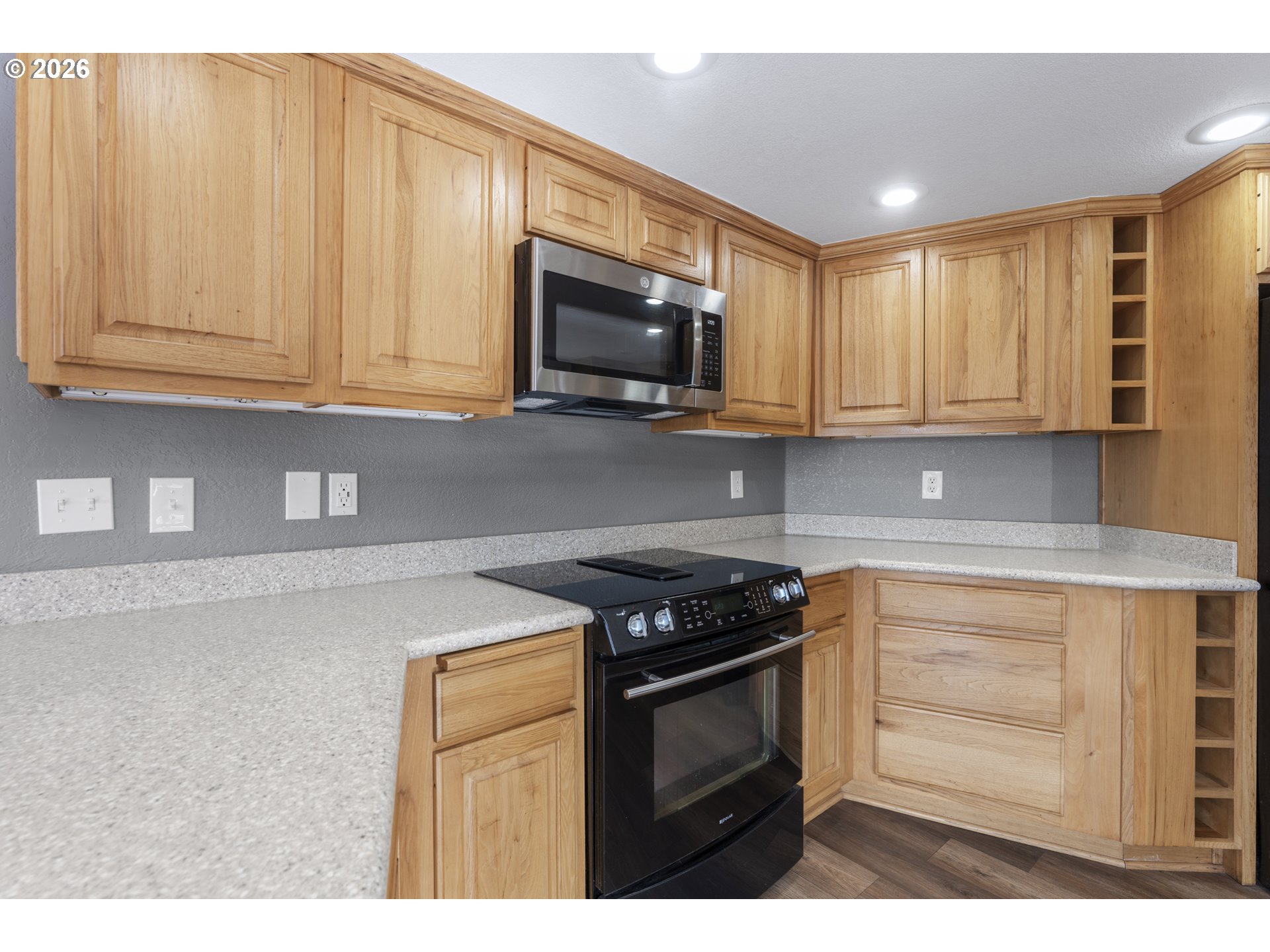 2453 Stephanie Lane North Bend, OR 97459 - Photo 12 of 48 a kitchen with stainless steel appliances granite countertop white cabinets and a stove top oven