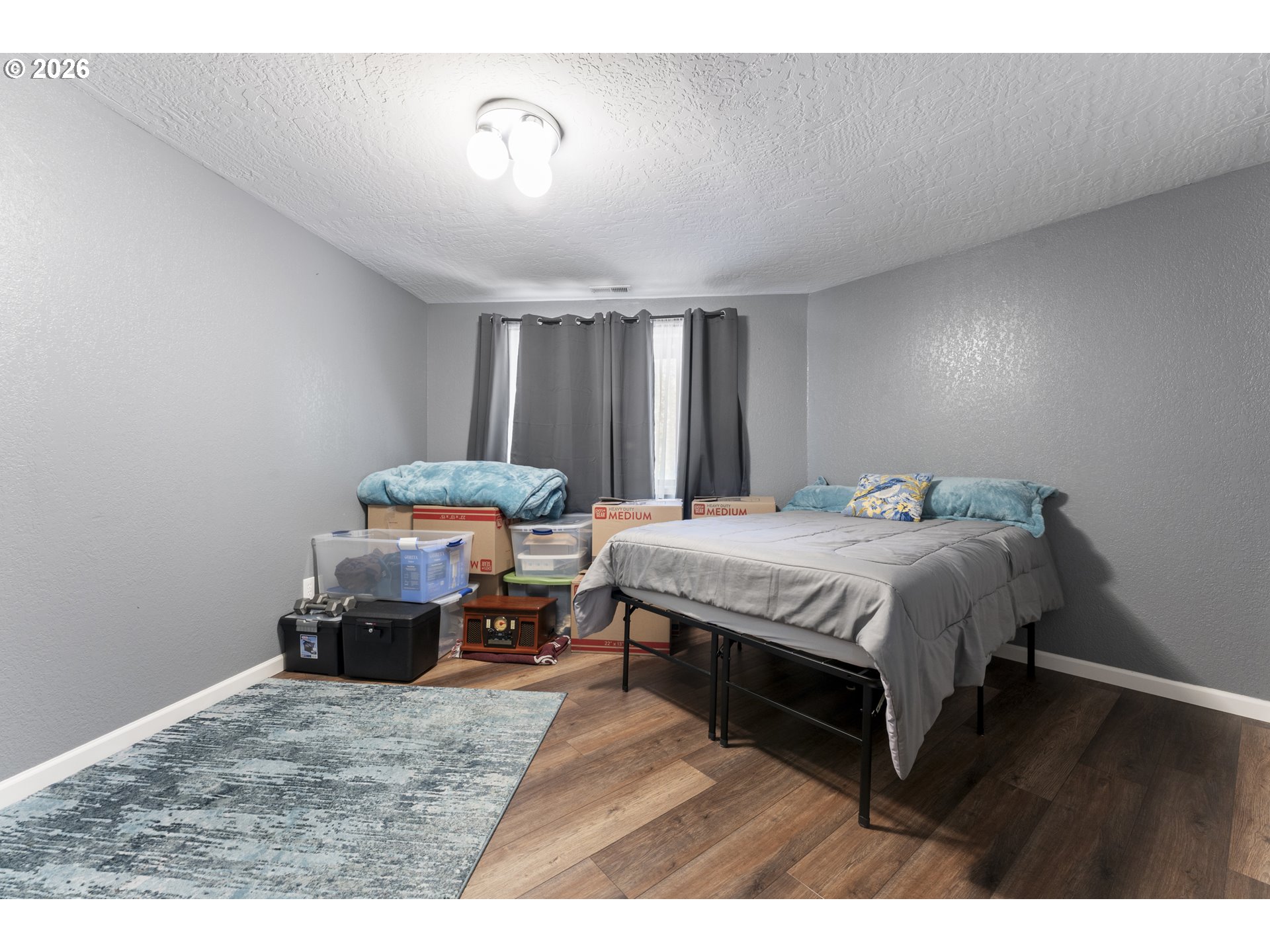 2453 Stephanie Lane North Bend, OR 97459 - Photo 26 of 48 a spacious bedroom with a bed and a table