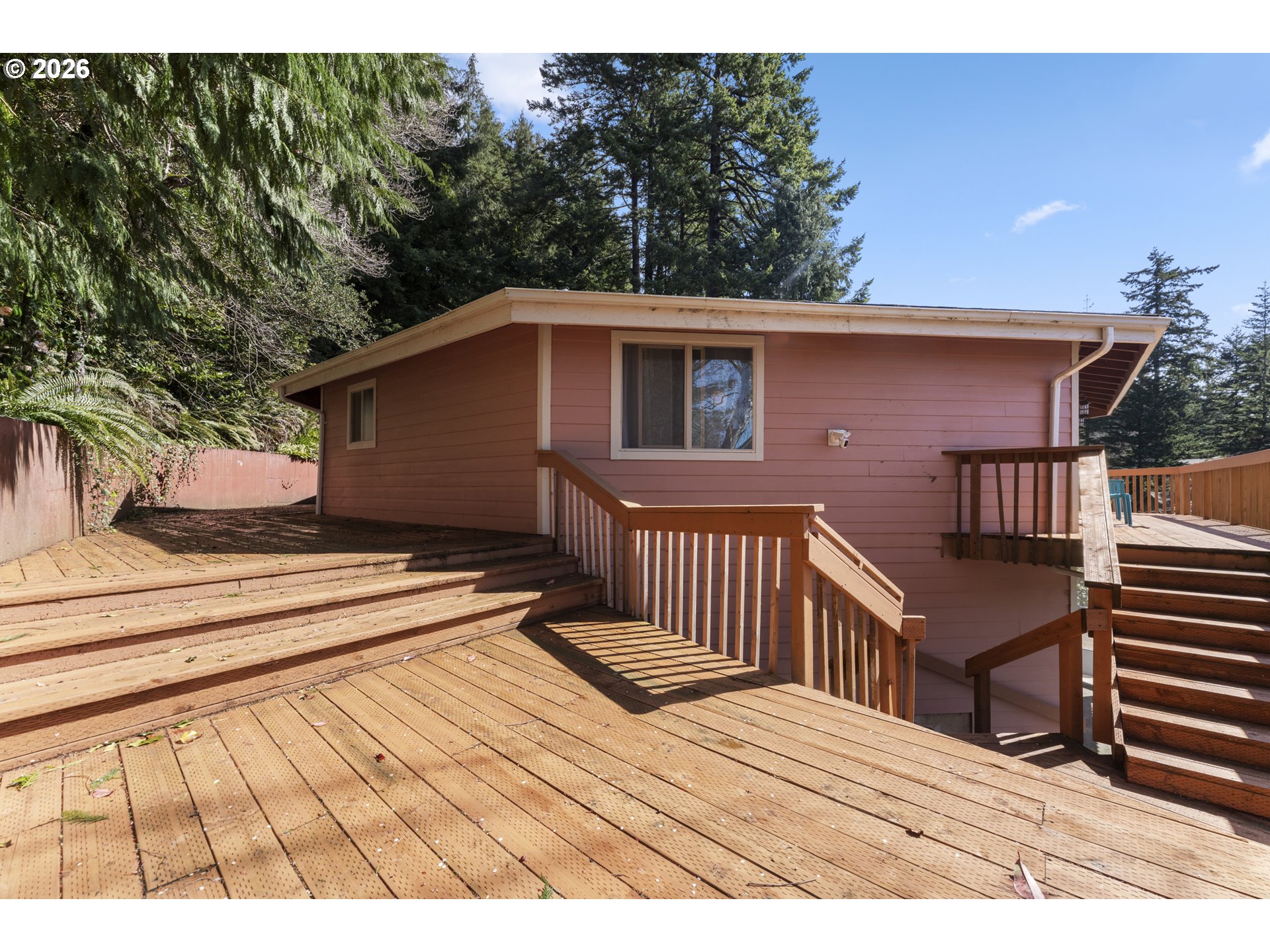 2453 Stephanie Lane North Bend, OR 97459 - Photo 35 of 48 a view of a house with wooden deck