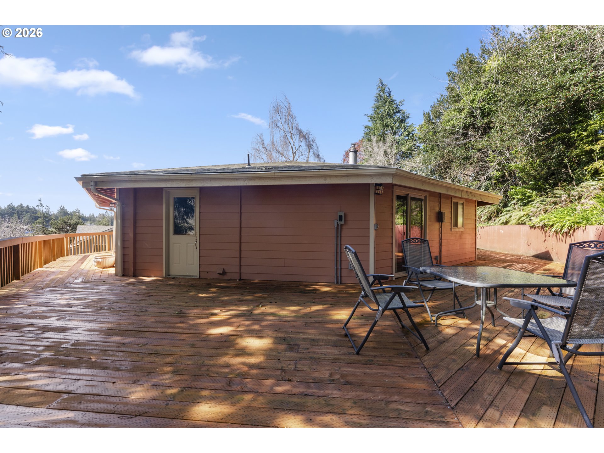 2453 Stephanie Lane North Bend, OR 97459 - Photo 38 of 48 a backyard of a house with table and chairs