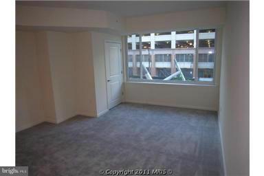 930 Wayne Avenue, Unit 207 Silver Spring, MD 20910 - Photo 7 of 9 a view of wooden floor and a window in a room