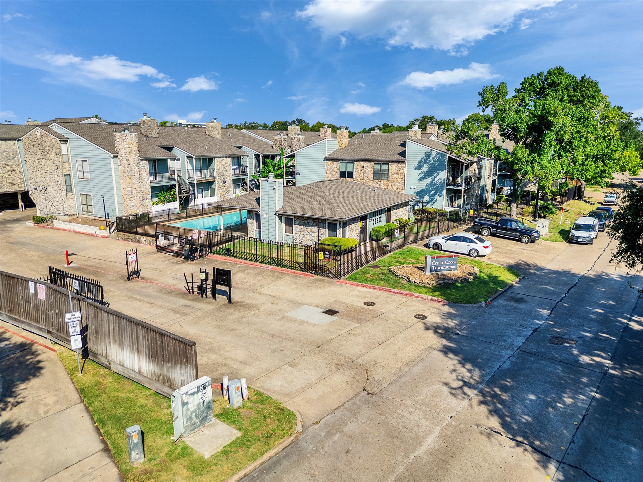 3764 Tanglewilde Street, Unit H8 Houston, TX 77063 - Photo 2 of 22 a view of a backyard with a patio and fire pit