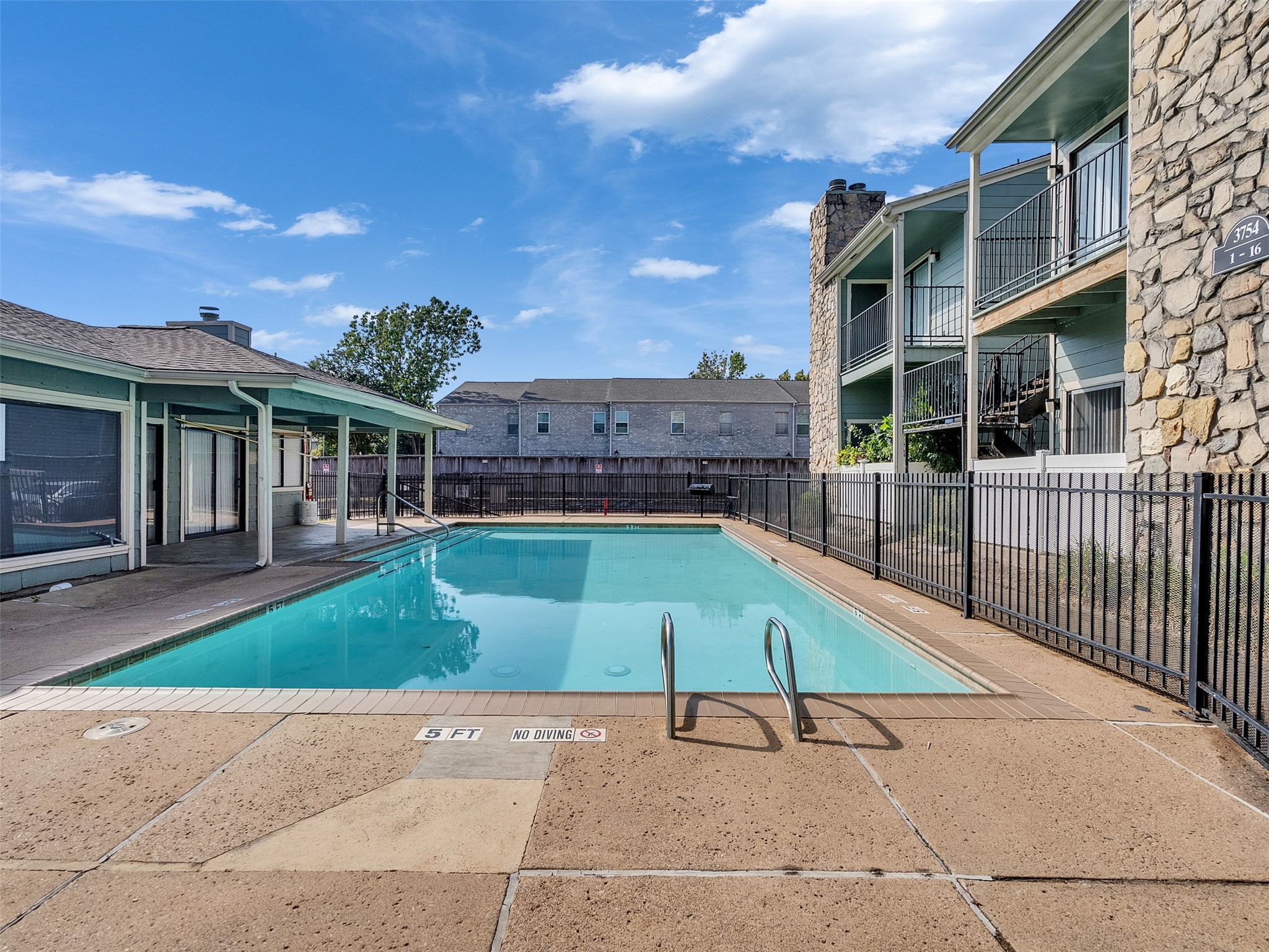 3764 Tanglewilde Street, Unit H8 Houston, TX 77063 - Photo 9 of 22 a house with trees in front of it